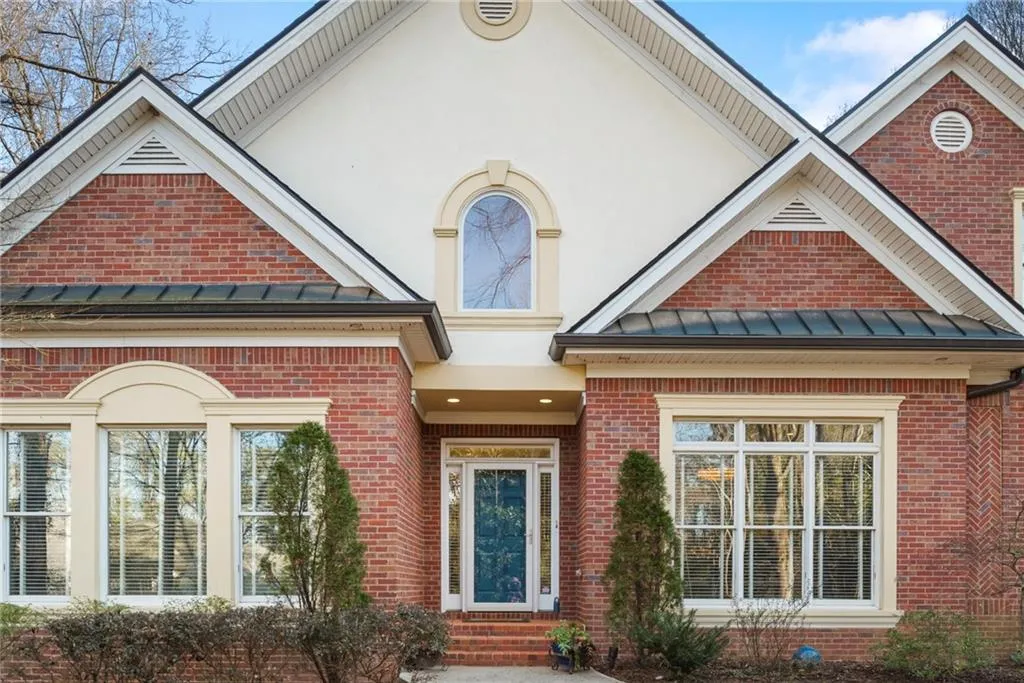 Updated windows, arched window and glass transom and sidelights provide natural light