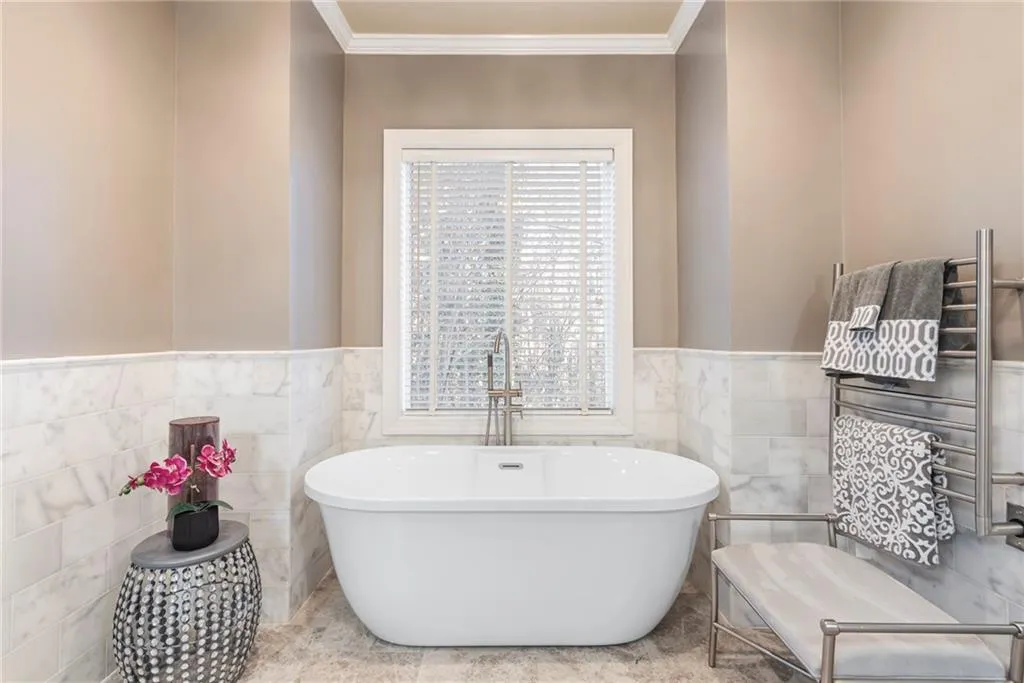 Soaking tub with updated plumbing and picture window - marble walls.