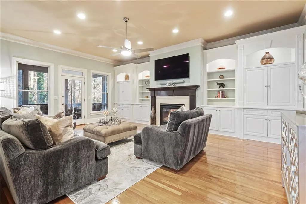 Fireplace is flanked by beautiful built-in cabinetry, gleaming hardwood floors.