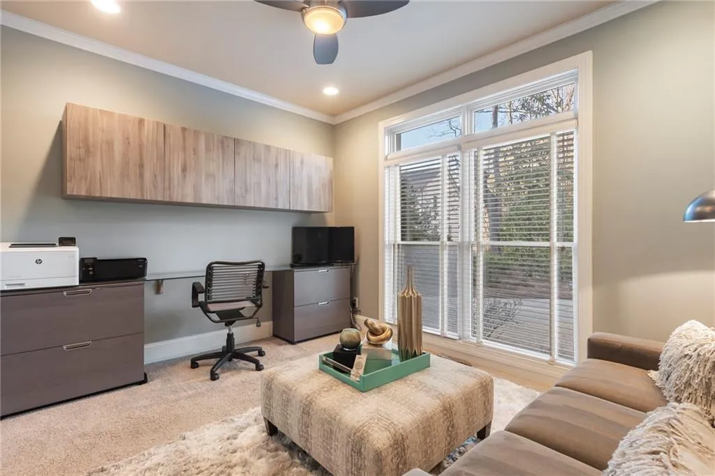 Main level secondary bedroom has built in cabinetry as ideal home office.