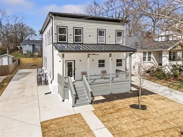 Modern farmhouse-style residence featuring a two-story design with white brick and light gray siding