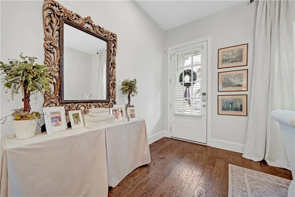 Entrance foyer with baseboards and dark wood-type flooring