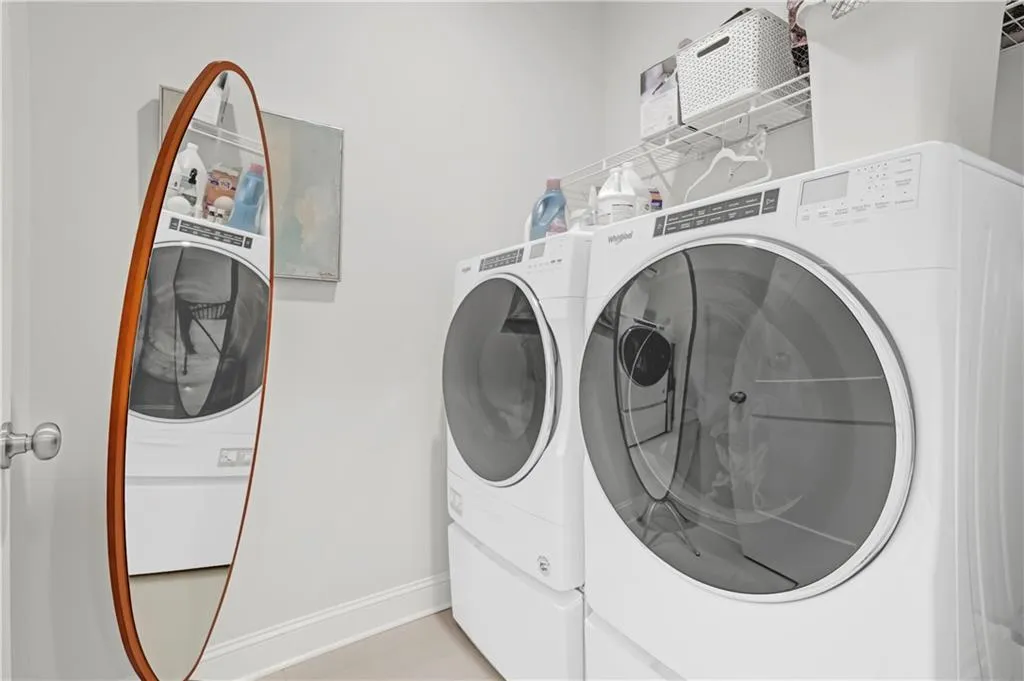 Washroom with baseboards and separate washer and dryer