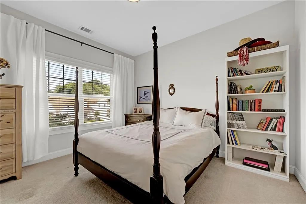 Bedroom featuring light carpet