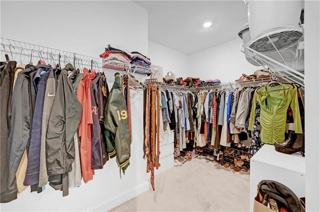 Walk in closet with carpet flooring