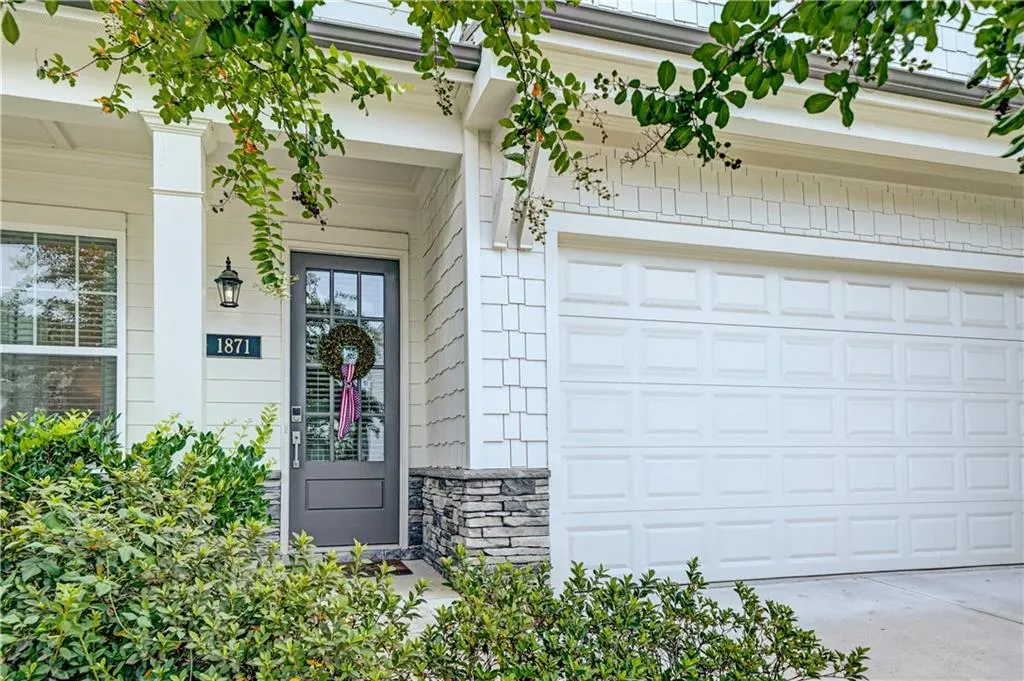 Doorway to property featuring driveway and stone siding