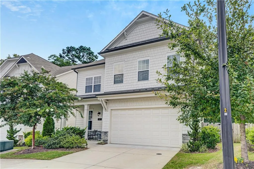 Craftsman-style home with concrete driveway and an attached garage