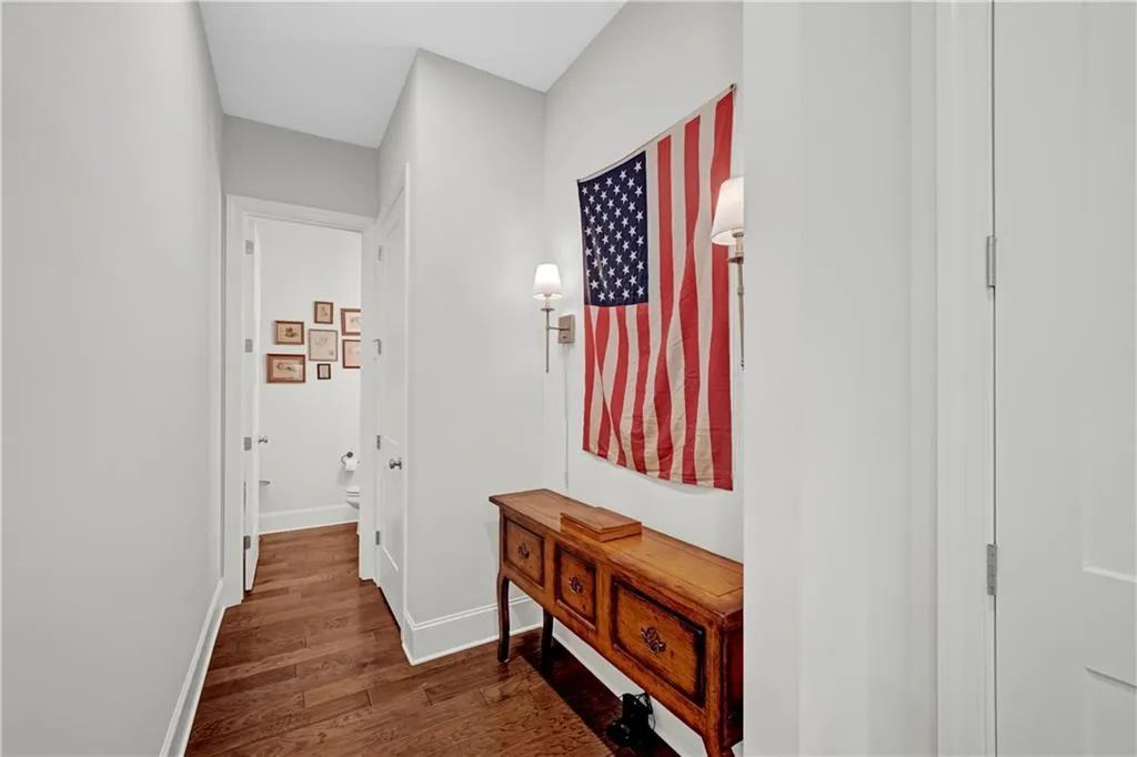 Hallway featuring dark wood finished floors and baseboards