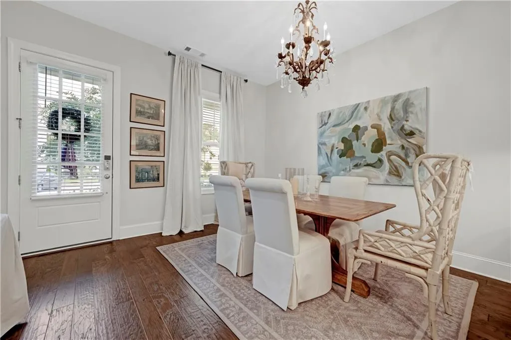 Dining space with dark wood finished floors and a chandelier