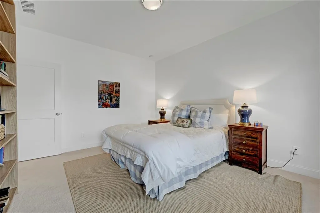 Bedroom featuring light carpet and baseboards