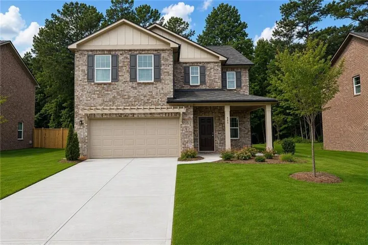 Brick facade with shuttered windows, covered front entry, attached two-car garage, and concrete driveway