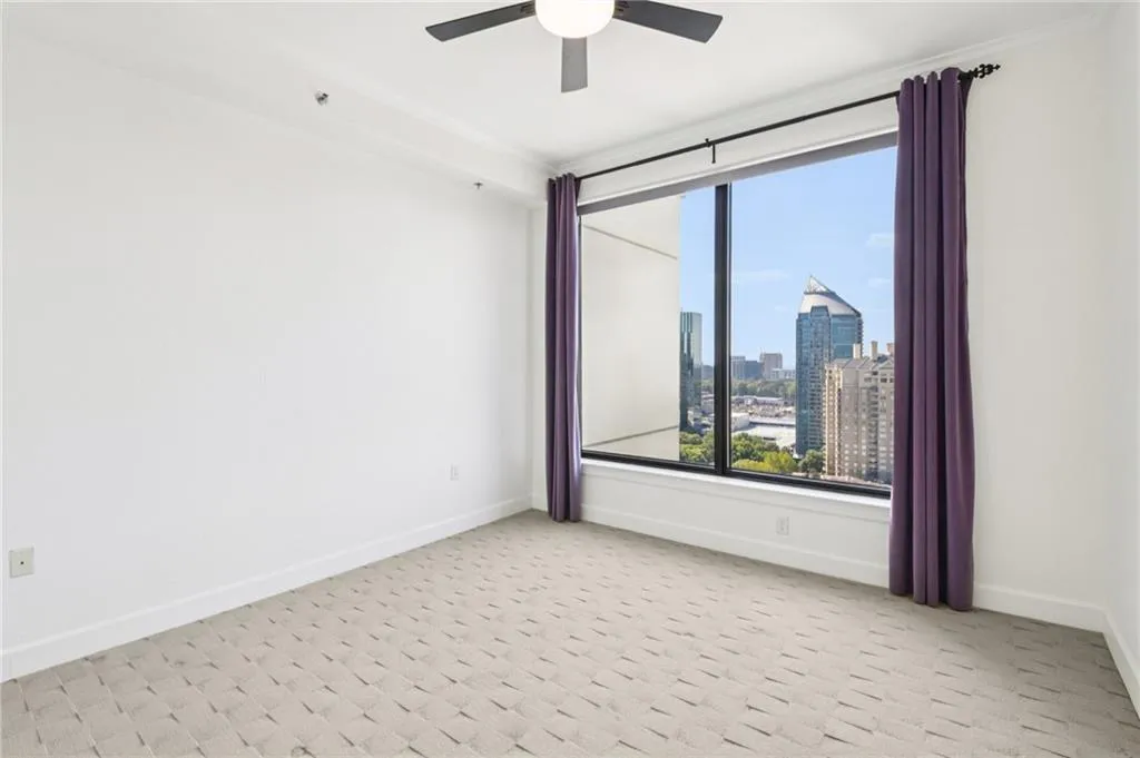 Spare room with a skyline view and light carpet