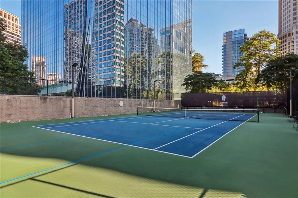 View of tennis court featuring a city view