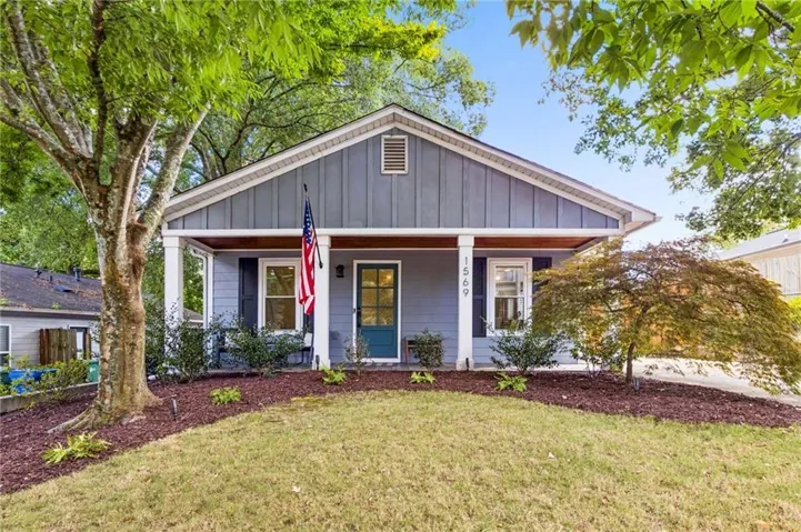 Front exterior with gray siding, white trim, and a covered porch