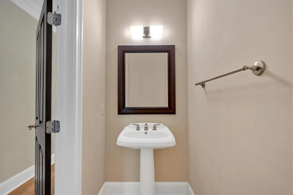 Bathroom featuring baseboards and wood finished floors