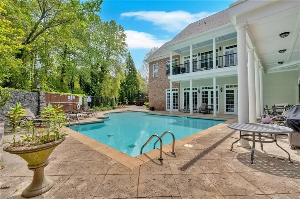 View of swimming pool with fence, a patio area, a fenced in pool, and french doors