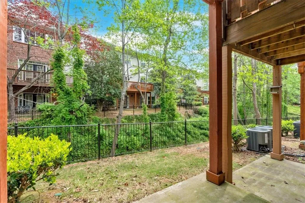 View of yard featuring central air condition unit, fence, and a patio