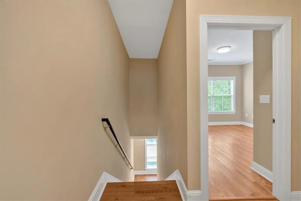 Stairs with baseboards and wood finished floors
