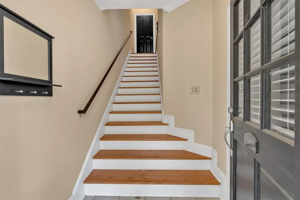 Stairway featuring baseboards and tile patterned floors