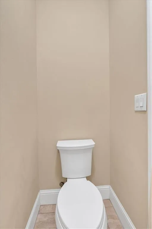 Bathroom with baseboards and toilet