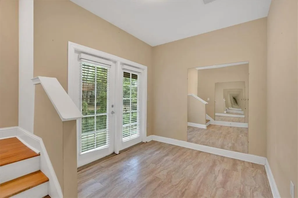 Doorway to outside featuring baseboards and stairway