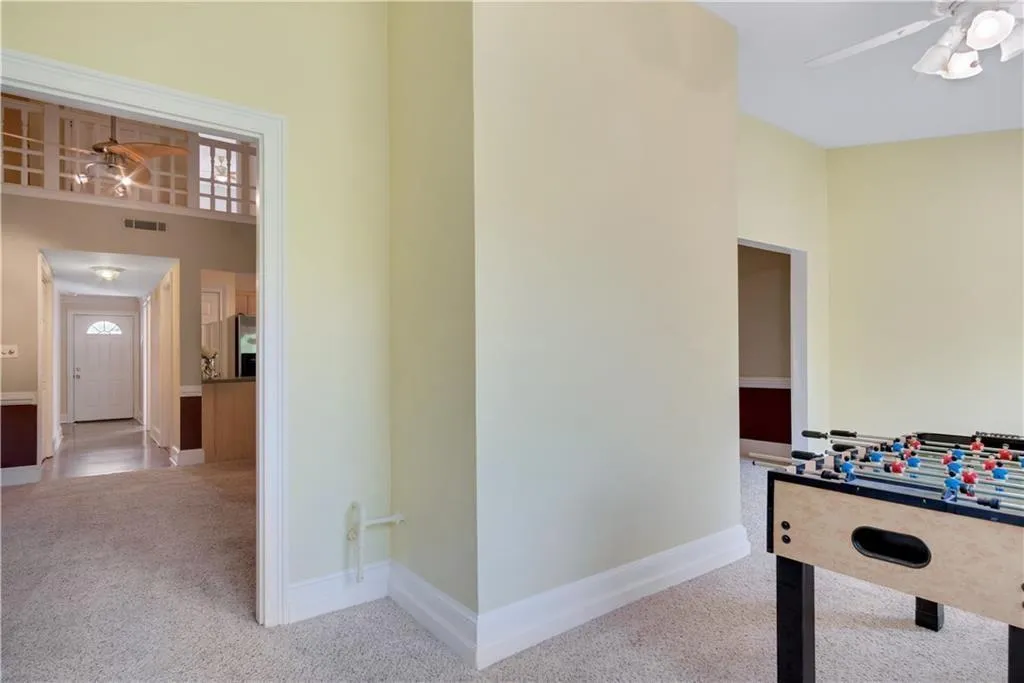 Playroom with visible vents, baseboards, a ceiling fan, and carpet flooring