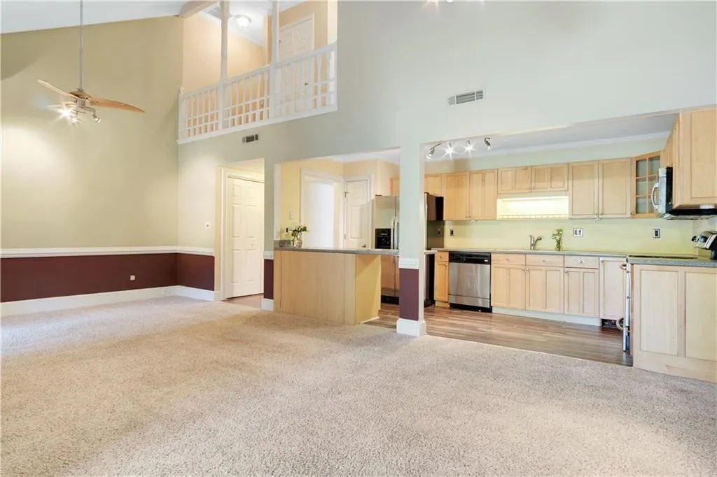 Kitchen featuring visible vents, light brown cabinets, stainless steel appliances, and ceiling fan