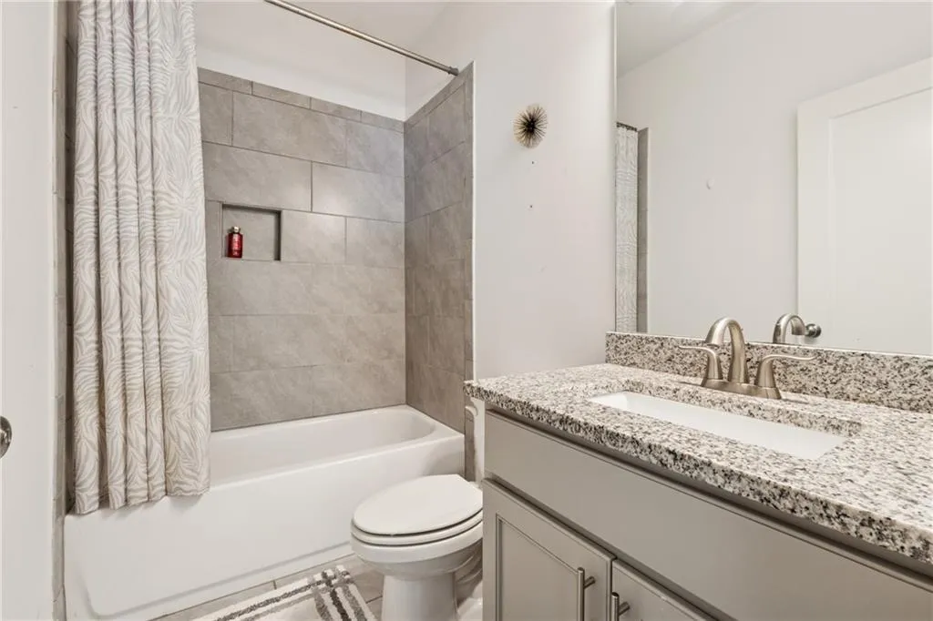 Bathroom with vanity and shower / bathtub combination with curtain