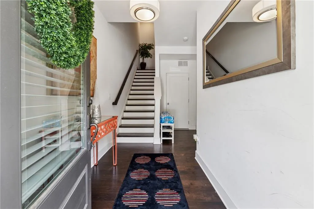 Foyer entrance featuring stairs and wood finished floors