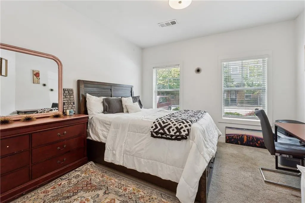 Bedroom with multiple windows and carpet flooring