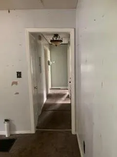 Corridor with carpet and baseboards