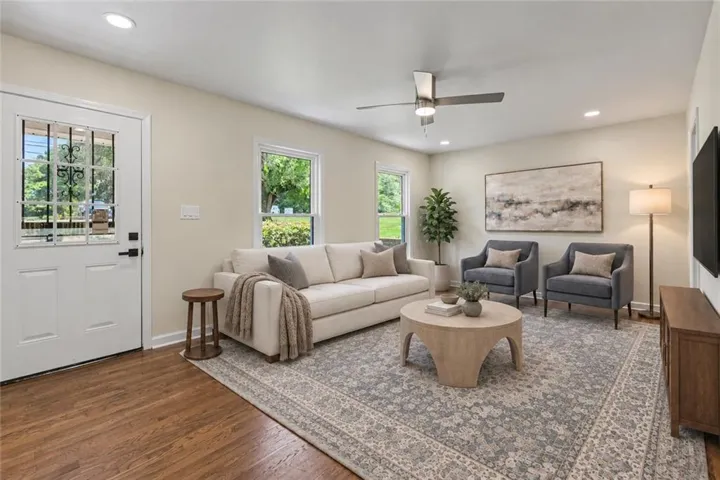 Recessed lighting, wood-finish flooring, ceiling fan, transom window, and paneled entry door