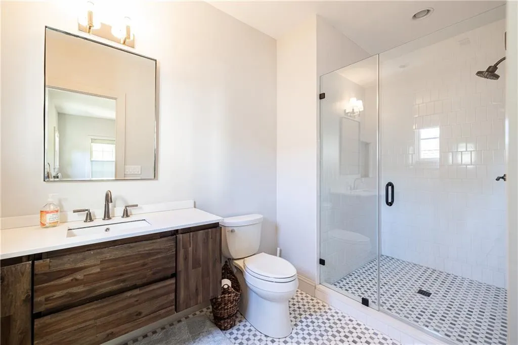 Beautifully renovated secondary bath with glass-enclosed shower