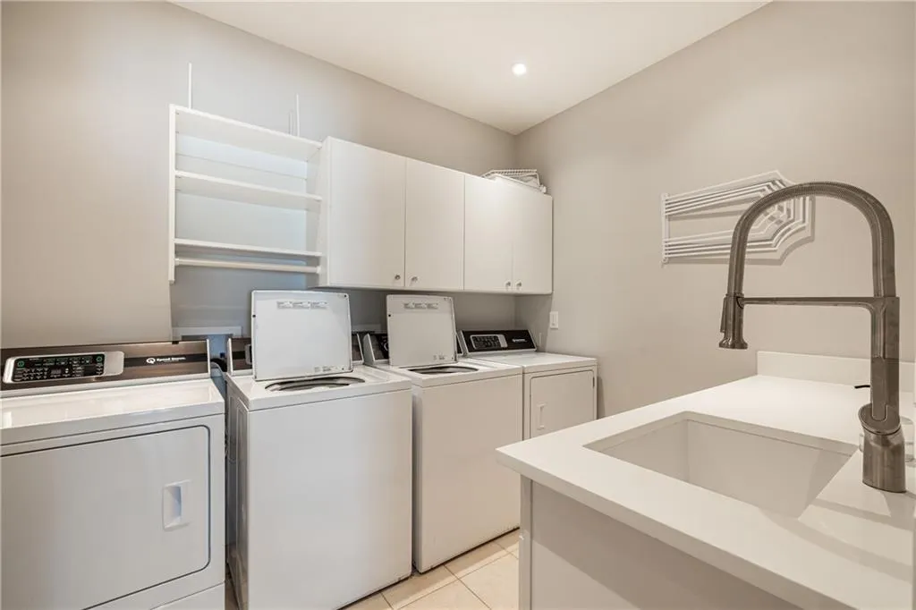 Convenient laundry room with ample cabinetry and counter space