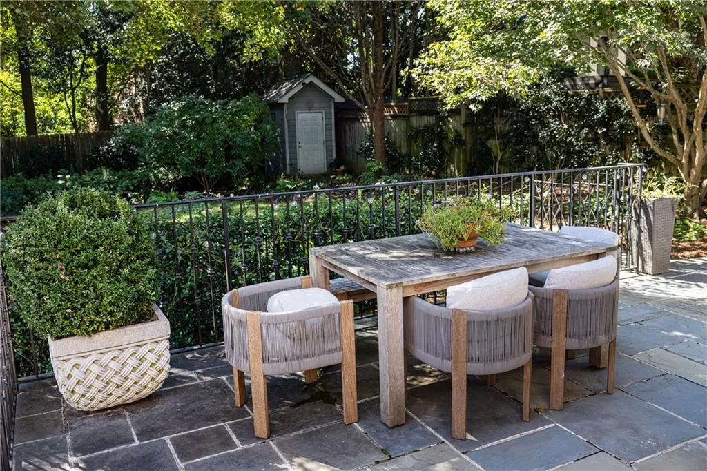 Beautiful stone patio overlooking lush landscaping