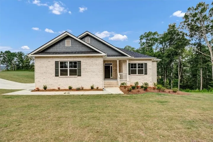 Light brick exterior with dark shingle accents