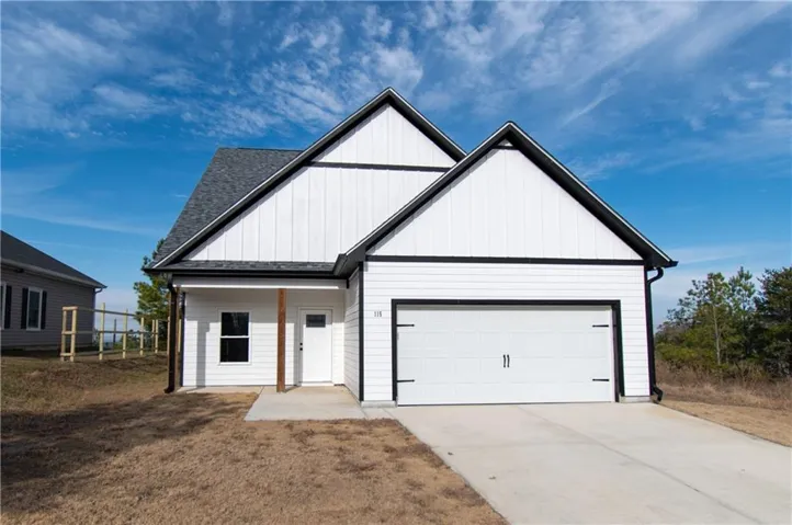 White exterior siding with dark trim, attached single-car garage, covered entry with a natural wood post, concrete driveway, and a shingled roof