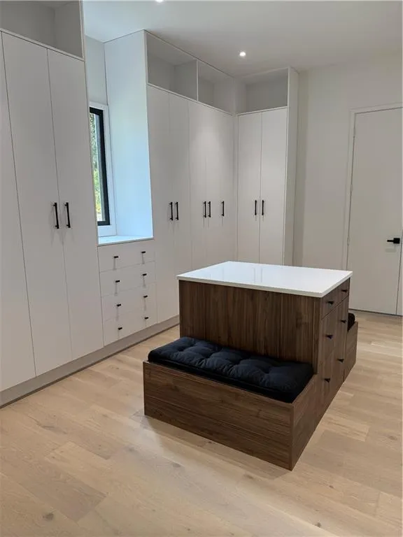 Bathroom with light wood-style flooring, a freestanding bath, and recessed lighting Bathroom with light wood-style flooring, a freestanding bath, and recessed lighting