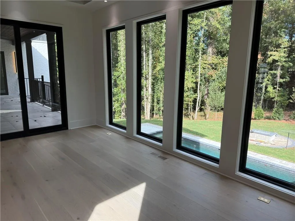 Doorway to outside with wood finished floors and baseboards Doorway to outside with wood finished floors and baseboards