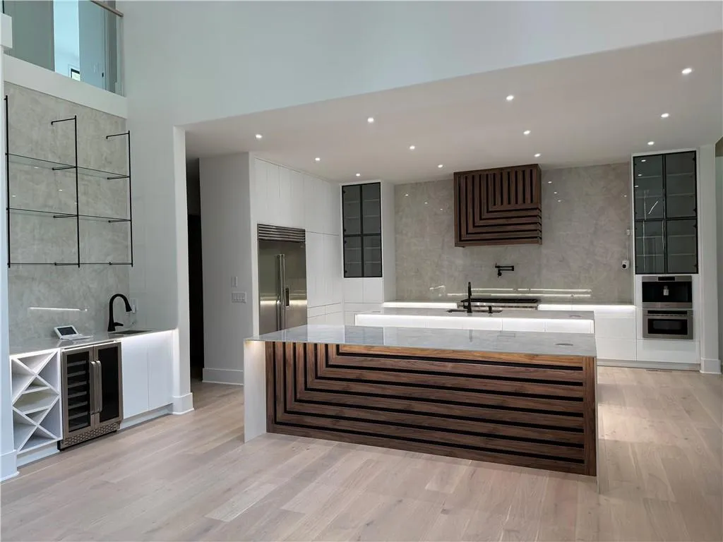 Full bathroom featuring backsplash, beverage cooler, light wood-type flooring, recessed lighting, and a tub Full bathroom featuring backsplash, beverage cooler, light wood-type flooring, recessed lighting, and a tub