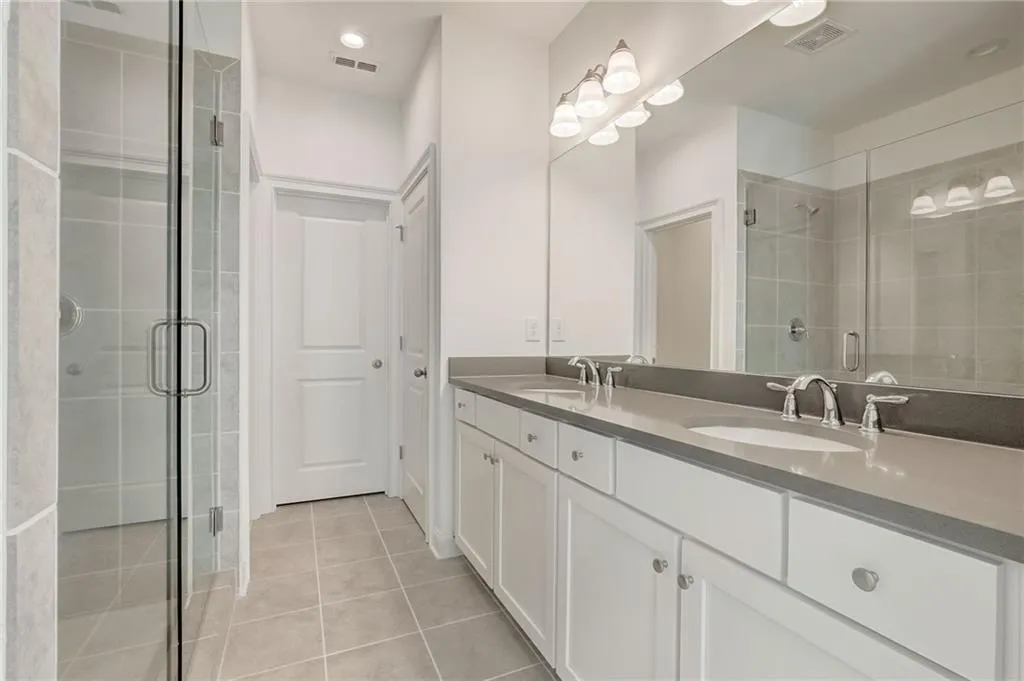 The Primary Suite features upgrade tile, countertops and plumbing fixtures.