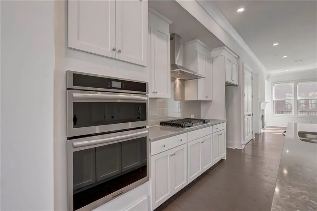 The kitchen offers built in micro/oven combo with 5 burner cooktop and stainless vent above.