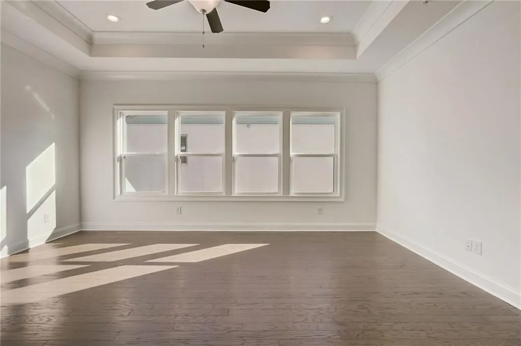 The Primary Suite has upgrade hardwoods and trey ceiling.
