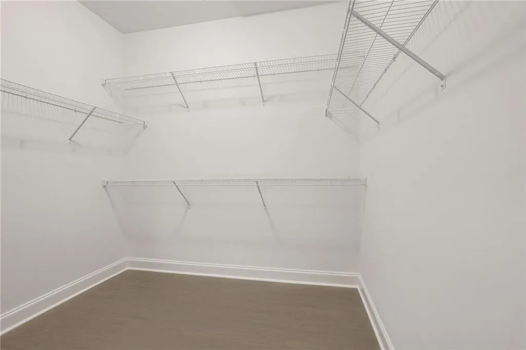 The Primary Closet is spacious featuring hardwood flooring upgrade.