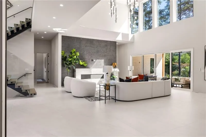 Living room with stairway and a high ceiling