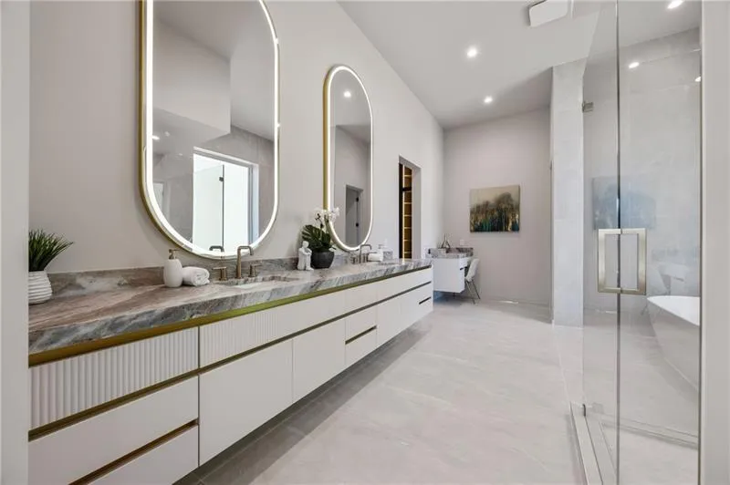 Bathroom featuring a freestanding tub, double vanity, a stall shower, and recessed lighting