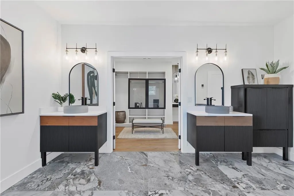 Bathroom featuring two vanities and marble tiled flooring