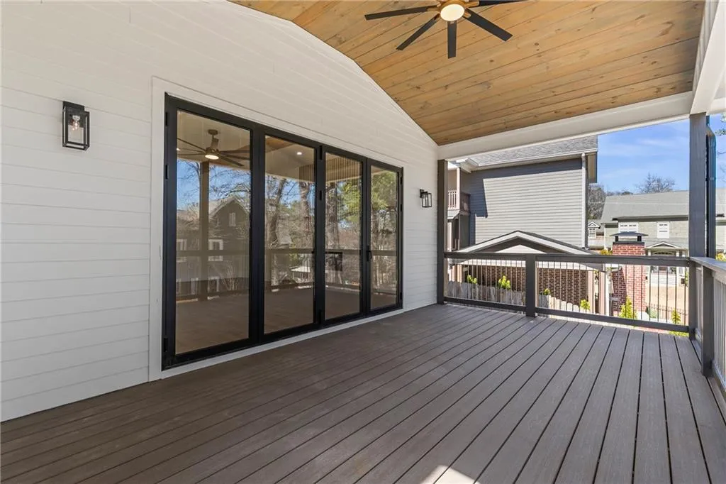 Wooden terrace featuring a ceiling fan