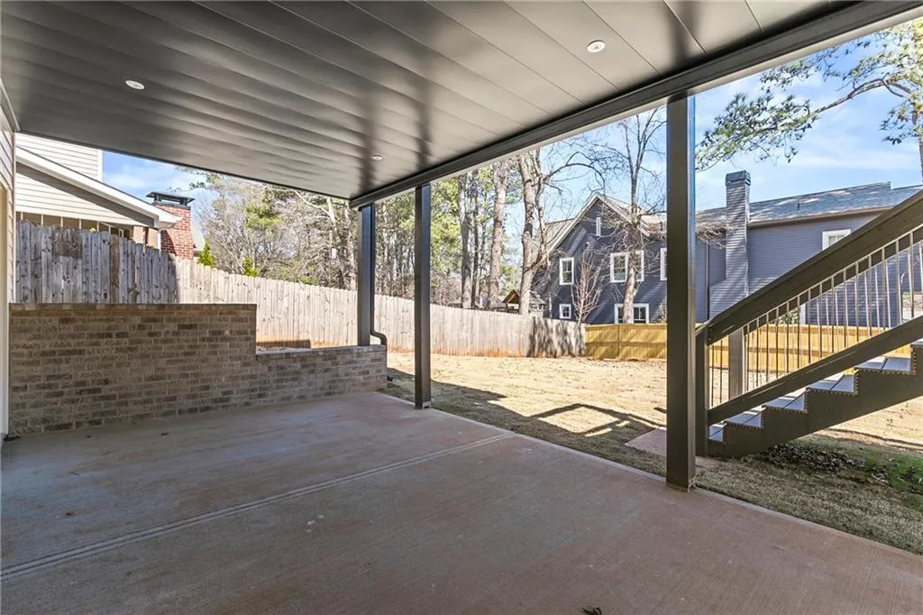 Fenced backyard featuring a patio and stairs