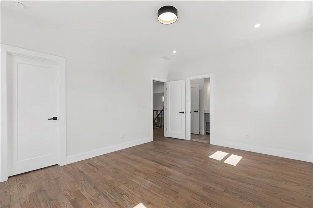 Unfurnished bedroom featuring wood finished floors and recessed lighting